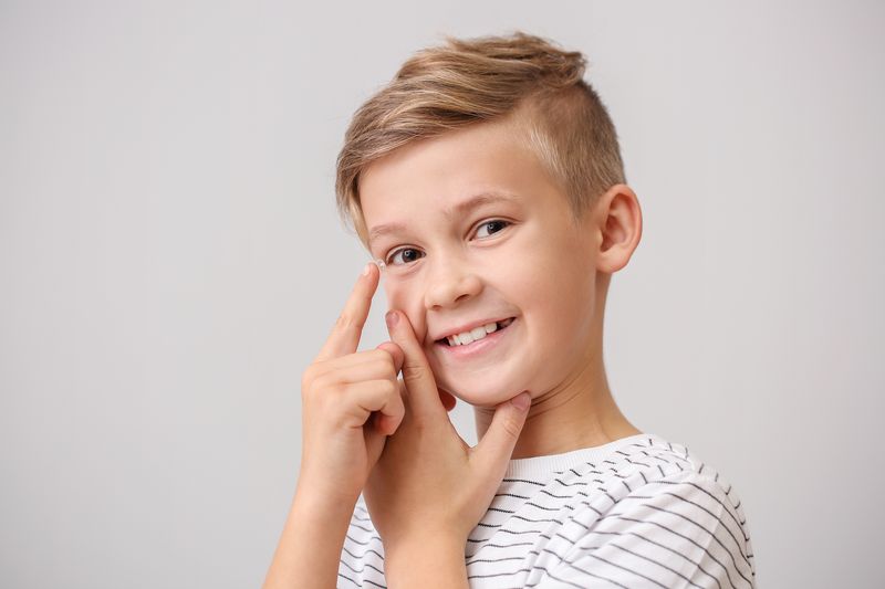 boy putting contact lens