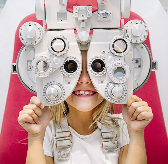happy kid taking her eye exam at crowder