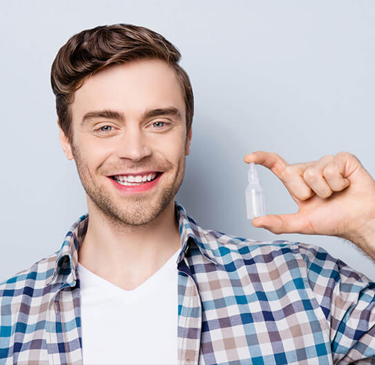 man holding eye drops