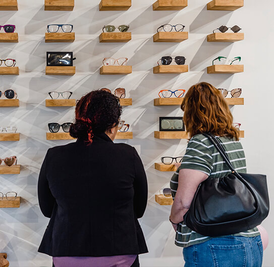 women picking glasses