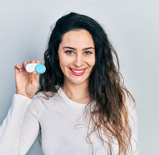 woman holding contact lenses