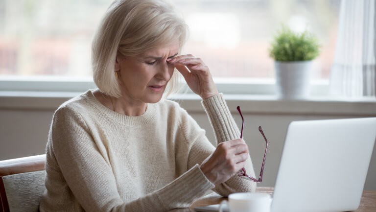 woman rubbing her eye